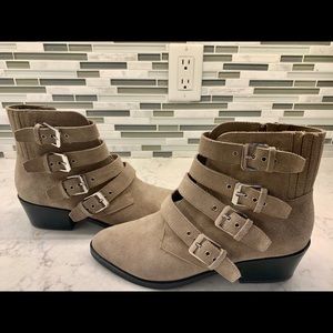 Taupe suede booties with buckles.